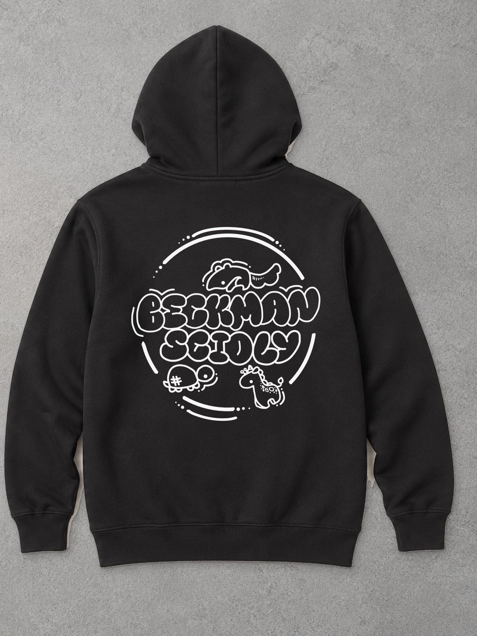 Studio mockup based on the black Independent Trading Co. SS4500 hoodie, with the official circular Beckman Scioly back graphic, rounded lettering, axolotl, turtle, and giraffe